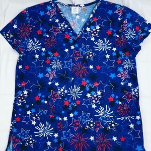 B-Scrubs- top only. Medium. Blue. Printed .V-shape and with 2 front pockets .